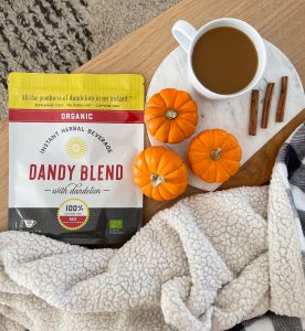 Photo of Dandy Blend package and drink, cinnamon sticks, small pumpkins