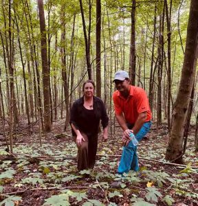 Jennifer Gerrity and Blake at the Herb Pharm Goldenseal forest plots. Photo by Susan Leopold, 2021.