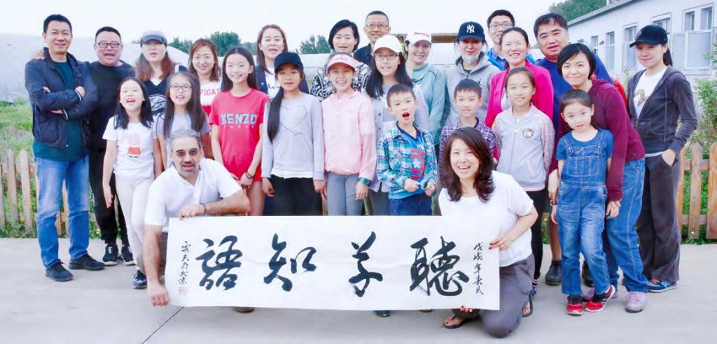 Post-class photo of Thomas and Holly with students and parents